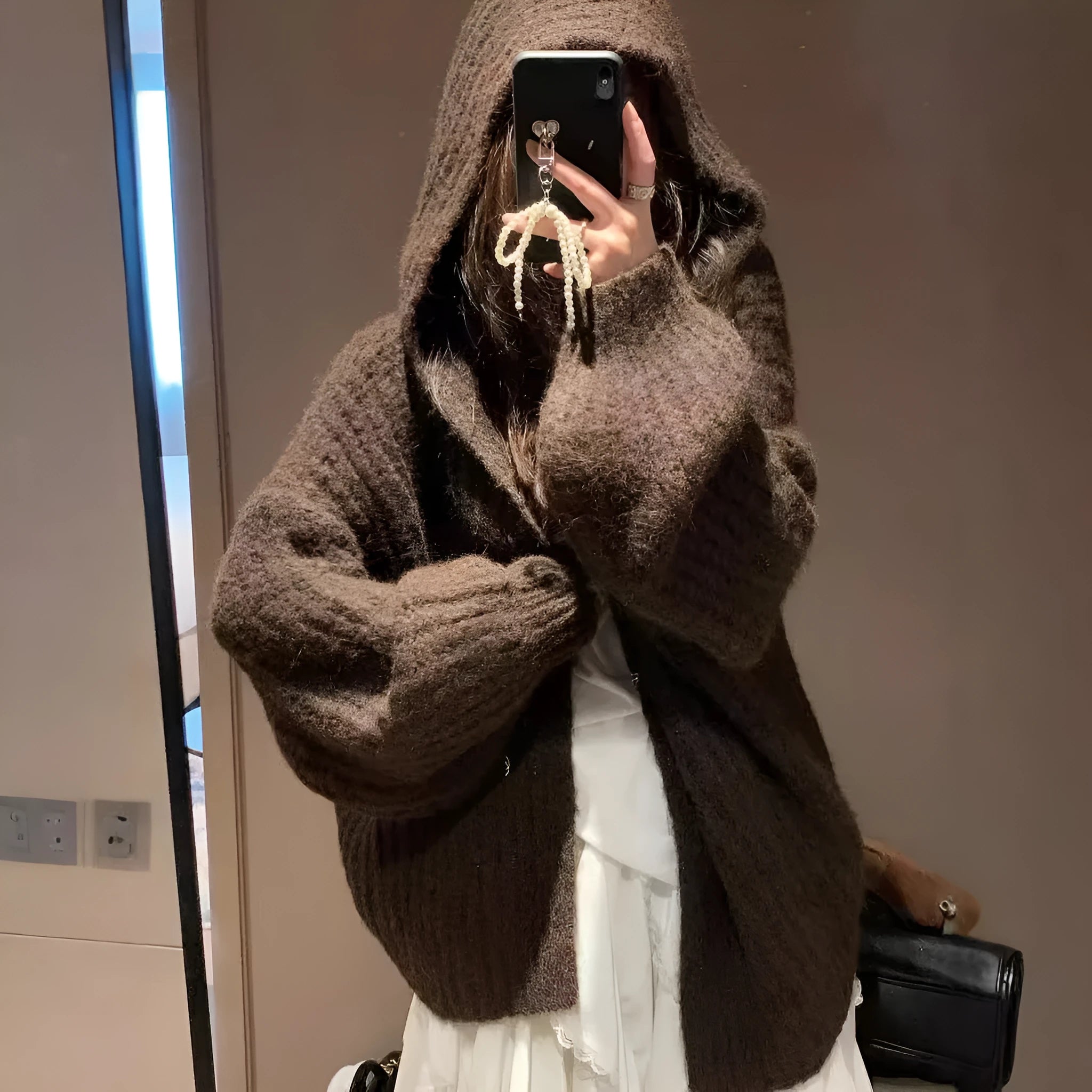 Brown women's loose-fit hooded acrylic sweater cardigan with retro style on a hanger.