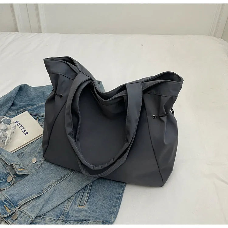 Oxford cloth folding tote bag in five colour options: black, brown, dark grey, light grey and purple.