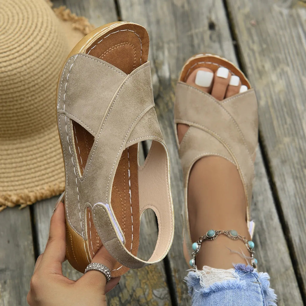 Women's brown Roman platform sandals with skirt detail and Velcro strap on a rubber sole.