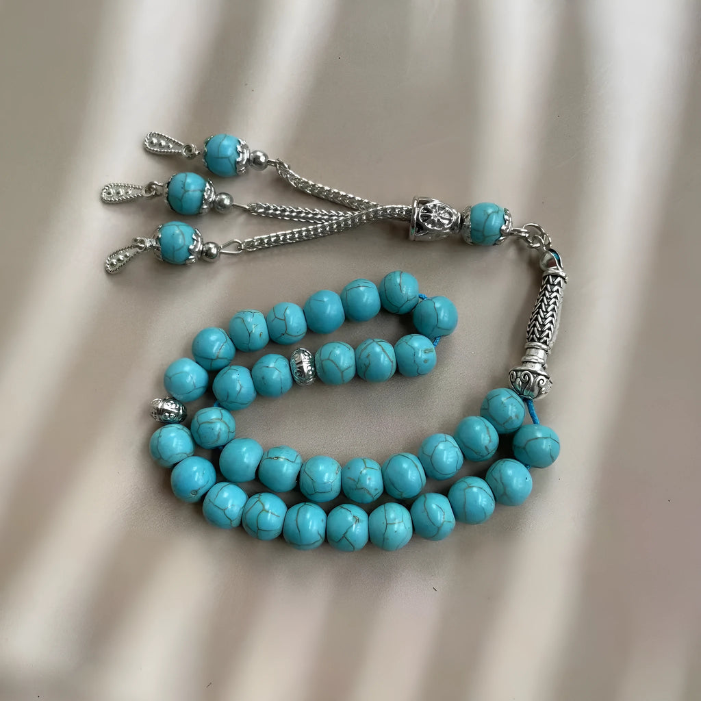 Sky blue stone Muslim dhikr bracelet with 8mm handmade beads on a wrist.