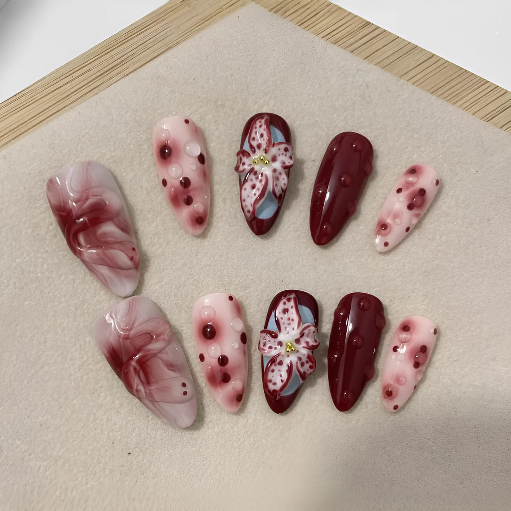 Hand-painted three-dimensional carved press-on nails with almond shape showing rose and tulip floral designs