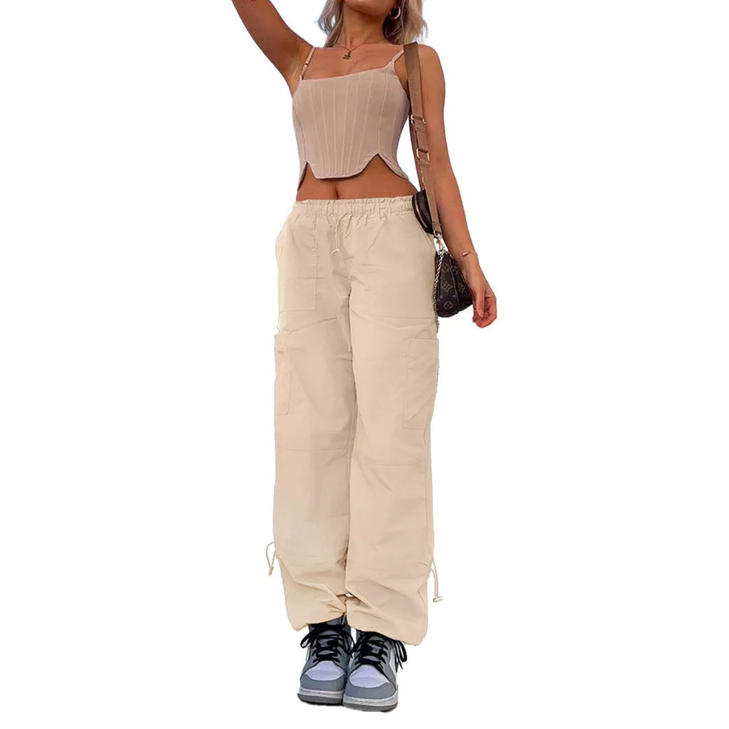 Loose-fit straight-leg cargo casual trousers in grey on a model, showing multiple pockets and mid-rise waist.