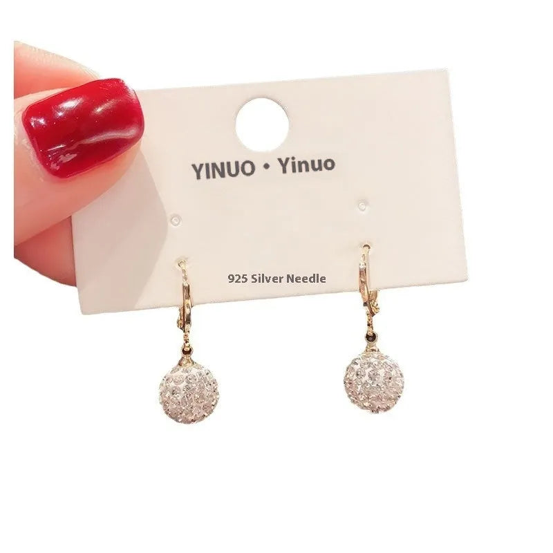 A pair of women's geometric rose design earrings in electroplated copper with zircon detail.