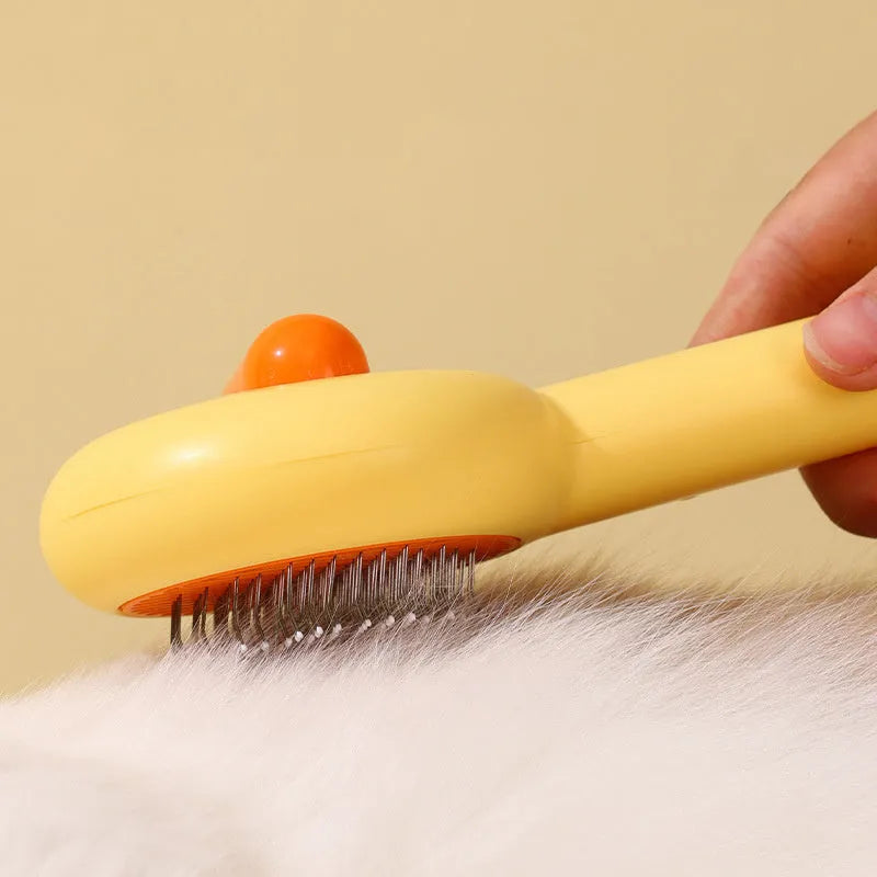 Small yellow duck-shaped pet comb with needle teeth for cat and dog grooming