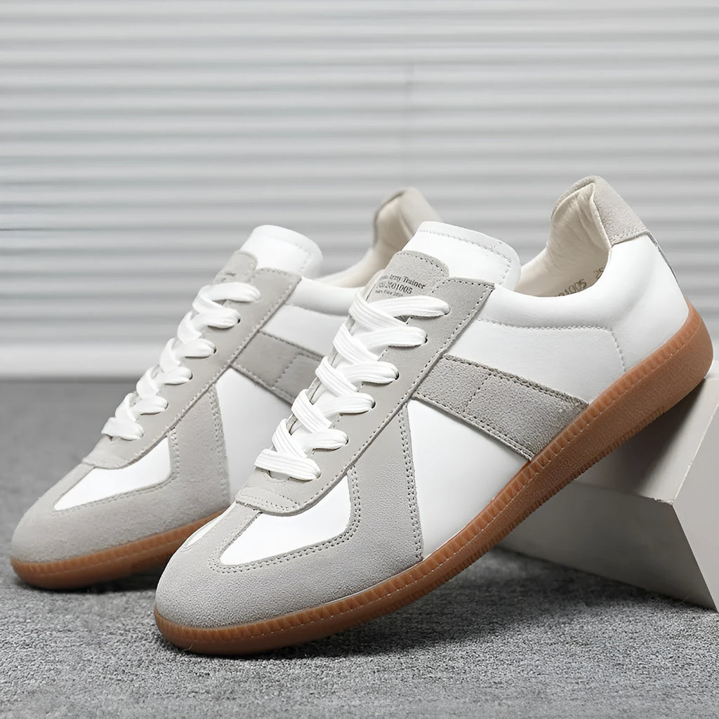 White Japanese retro low-top sneakers with round toe and lace-up front on a rubber sole.