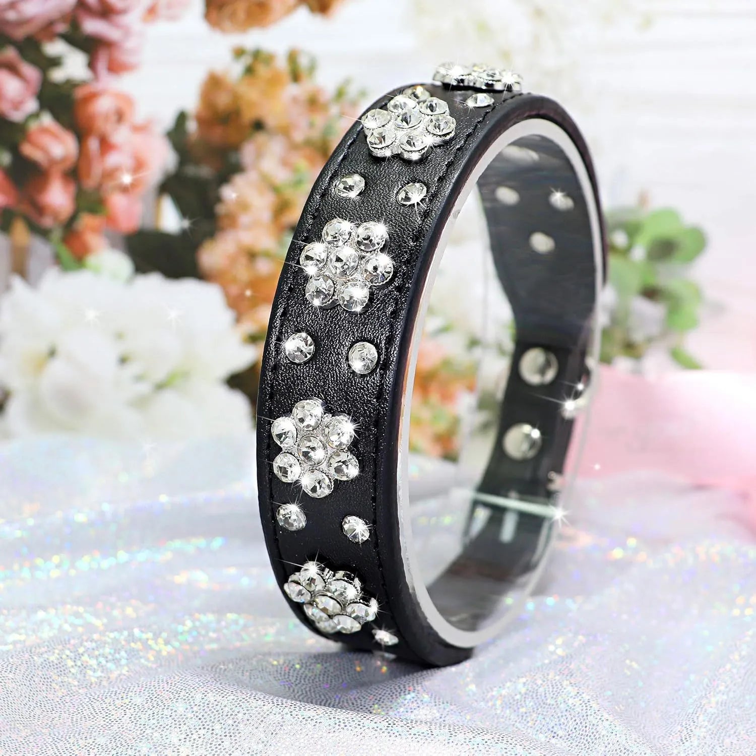 PU leather dog collar with rhinestone flower pattern and metal D-ring on a white background