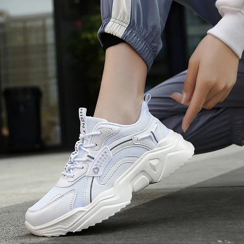 Women's white thick-soled casual sports shoes with mesh upper and buckle detail in Moonlight colour.