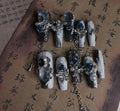 Heavy industry blue manicure nails with rose and tulip floral patterns in plastic armour suit packaging