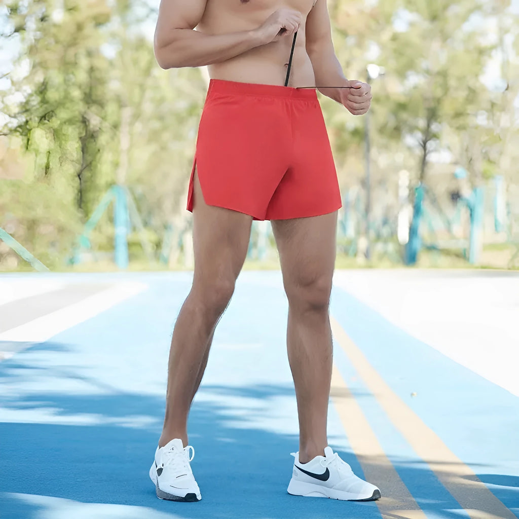 Men's loose fit off-road running shorts in red, shown with high waist and quick-dry fabric for marathon running.
