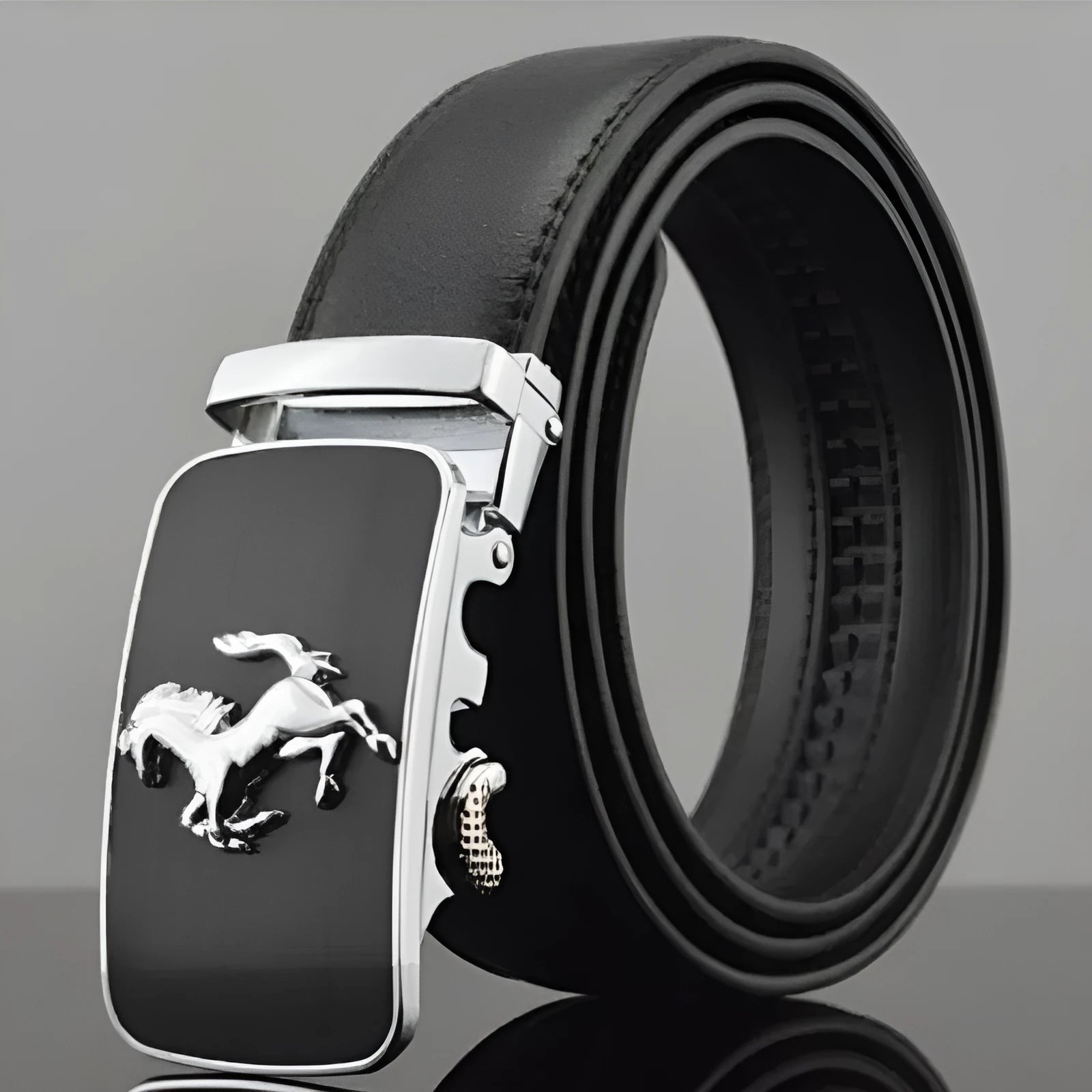 Men's black leather automatic buckle belt with a chrome buckle, showing the push-through fastening mechanism.