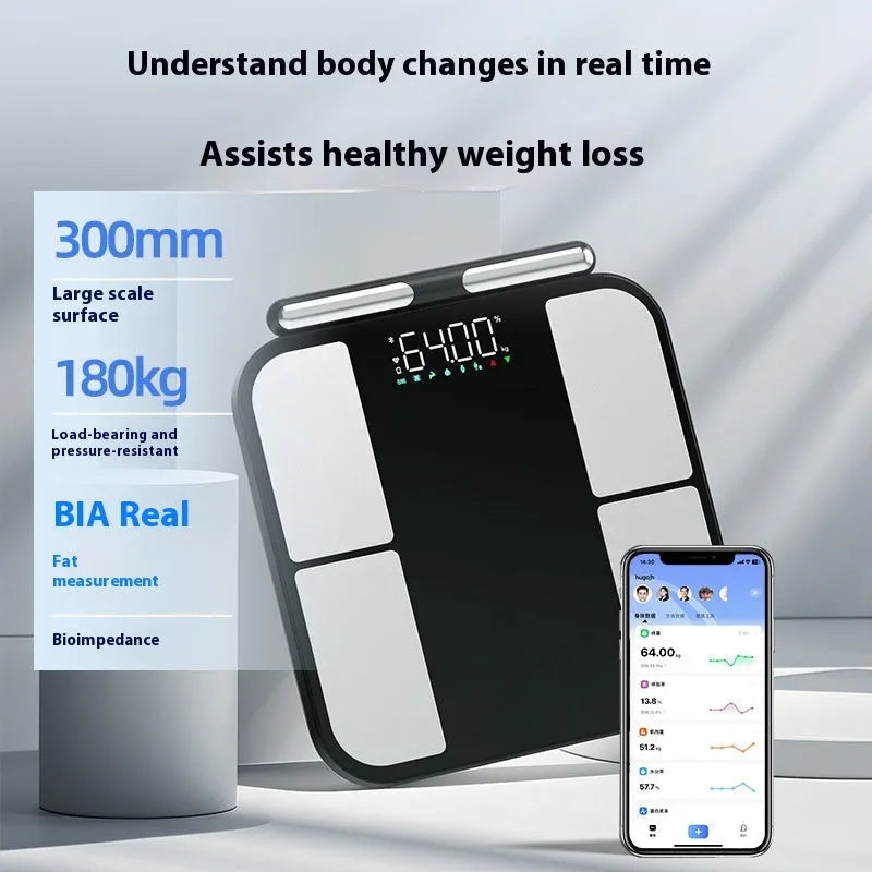 Black electronic body analysis scale with a tempered glass platform on a bathroom floor.