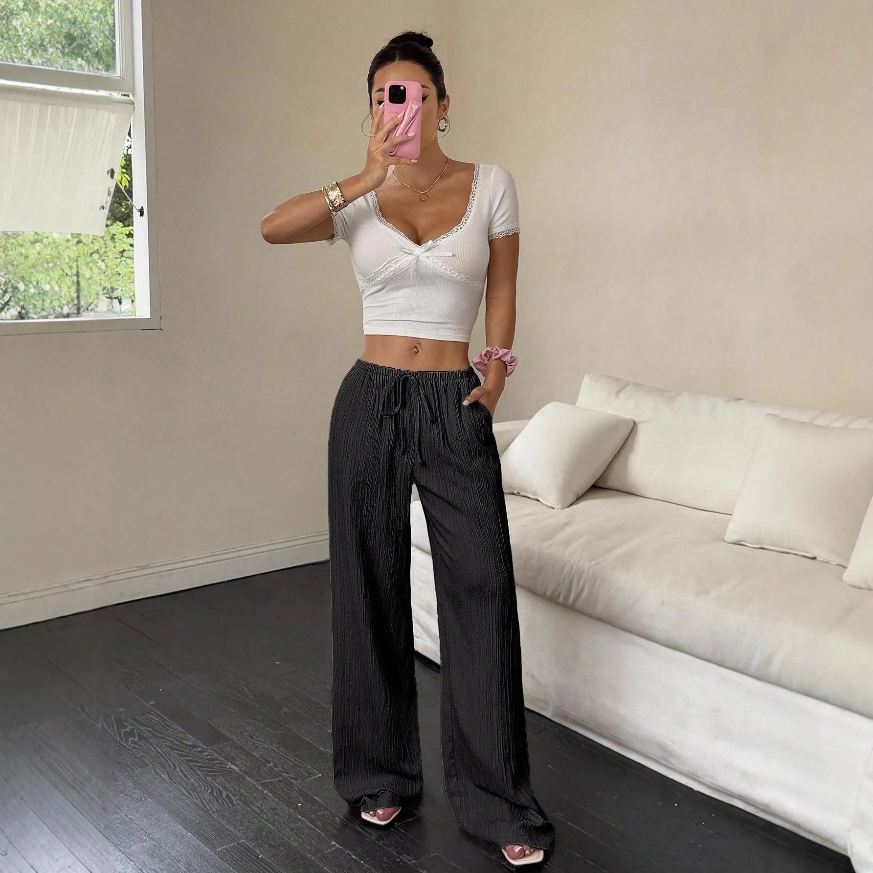 Women's wide leg casual trousers with lace-up waist detail in black and pink.