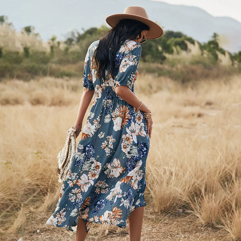 Yellow floral print women's summer dress with V-neck and elastic waist on a hanger