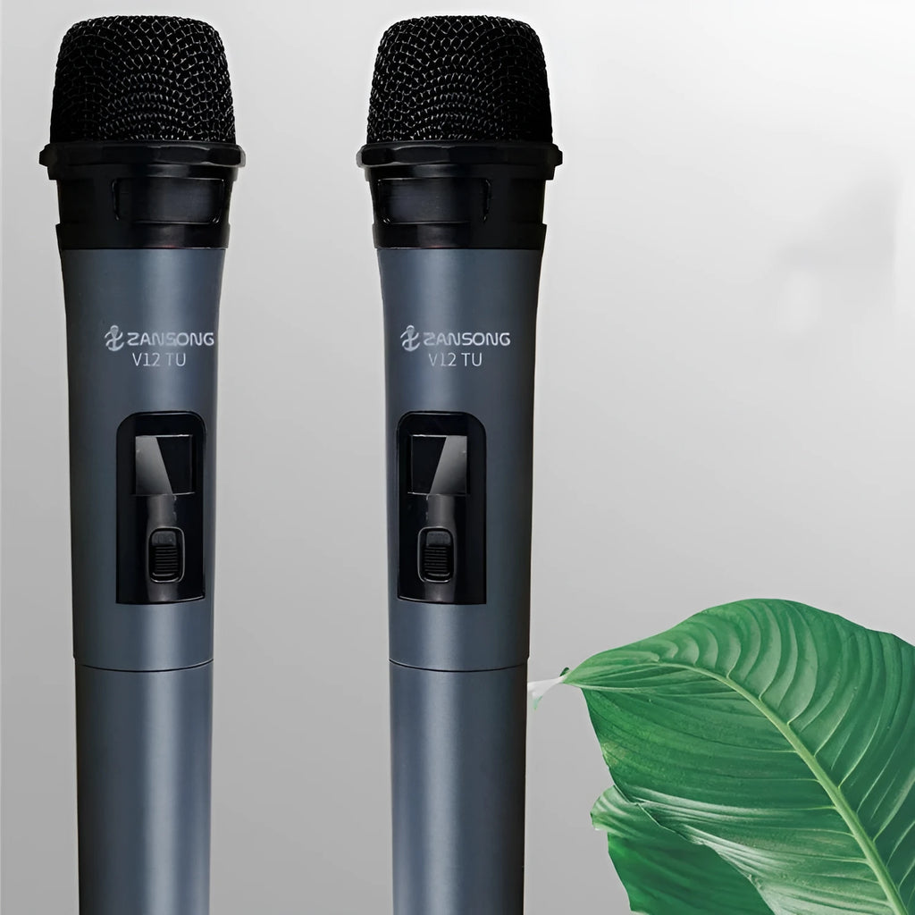 Black ZANSONG V12 dynamic wireless microphone with USB receiver and cables on a table.
