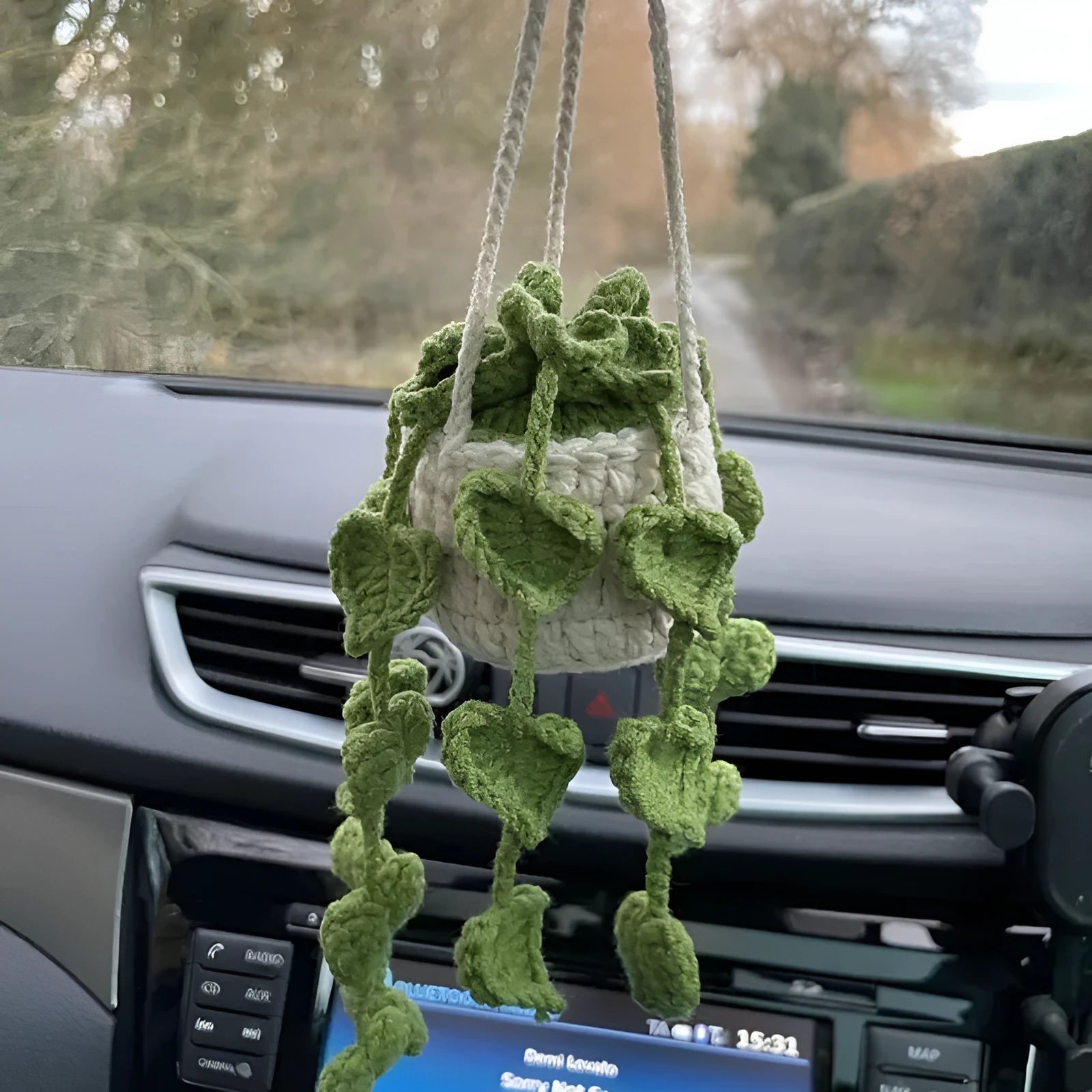 Knitted green and white car plant decoration with hanging rope
