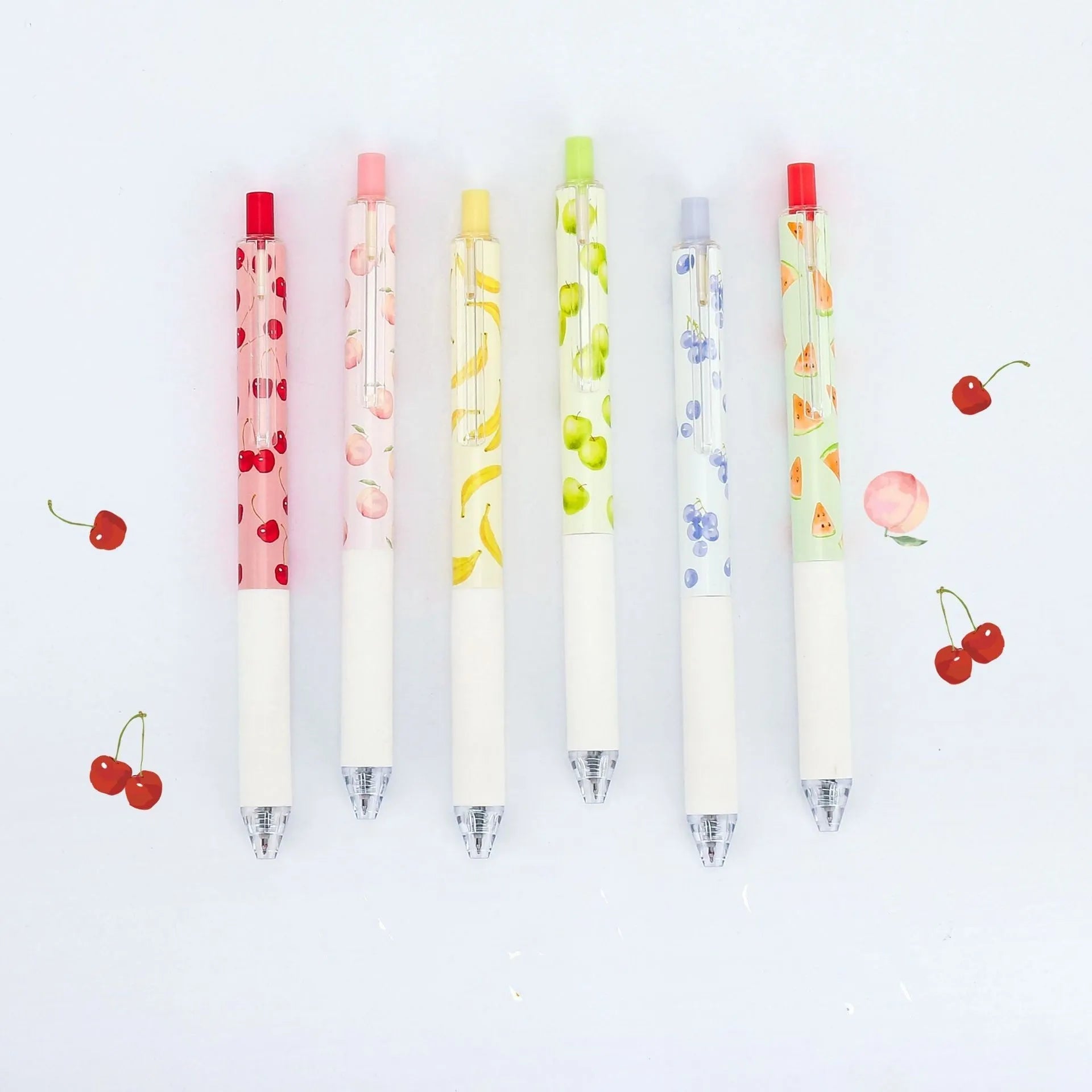 Three fruit-scented gel ink pens with 0.5mm black refills and press-action click mechanism