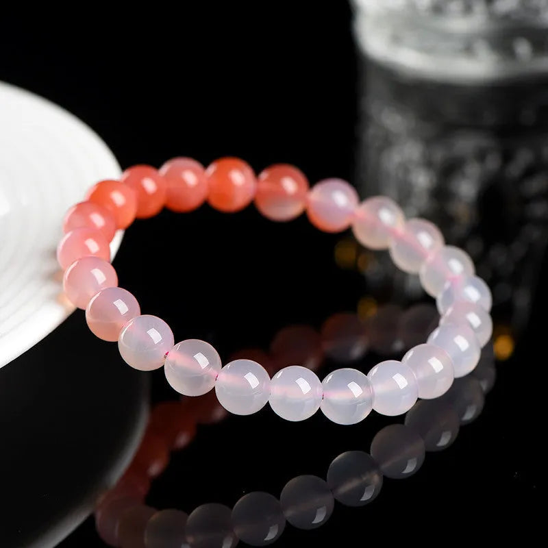 Natural gradient Yanyuan agate bracelet with geometry-cut beads on a wrist, showing salt source colour variation.