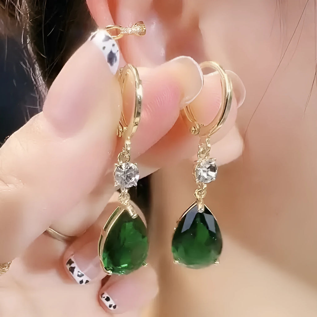 A pair of emerald green geometric teardrop earrings made from alloy.