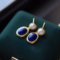 Silver earrings with blue lapis lazuli pearls and auspicious pattern details
