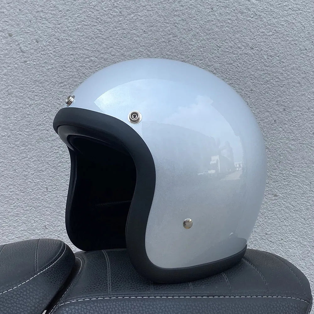 Glass fibre motorcycle half helmet shown in a retro style on a stand.