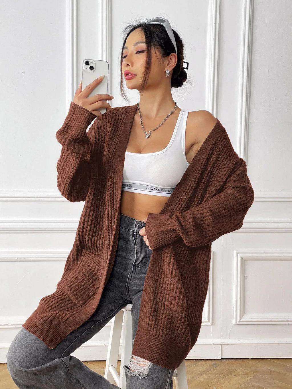 Loose fit women's acrylic cardigan sweater with double pockets in solid color