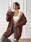 Loose fit women's acrylic cardigan sweater with double pockets in solid color