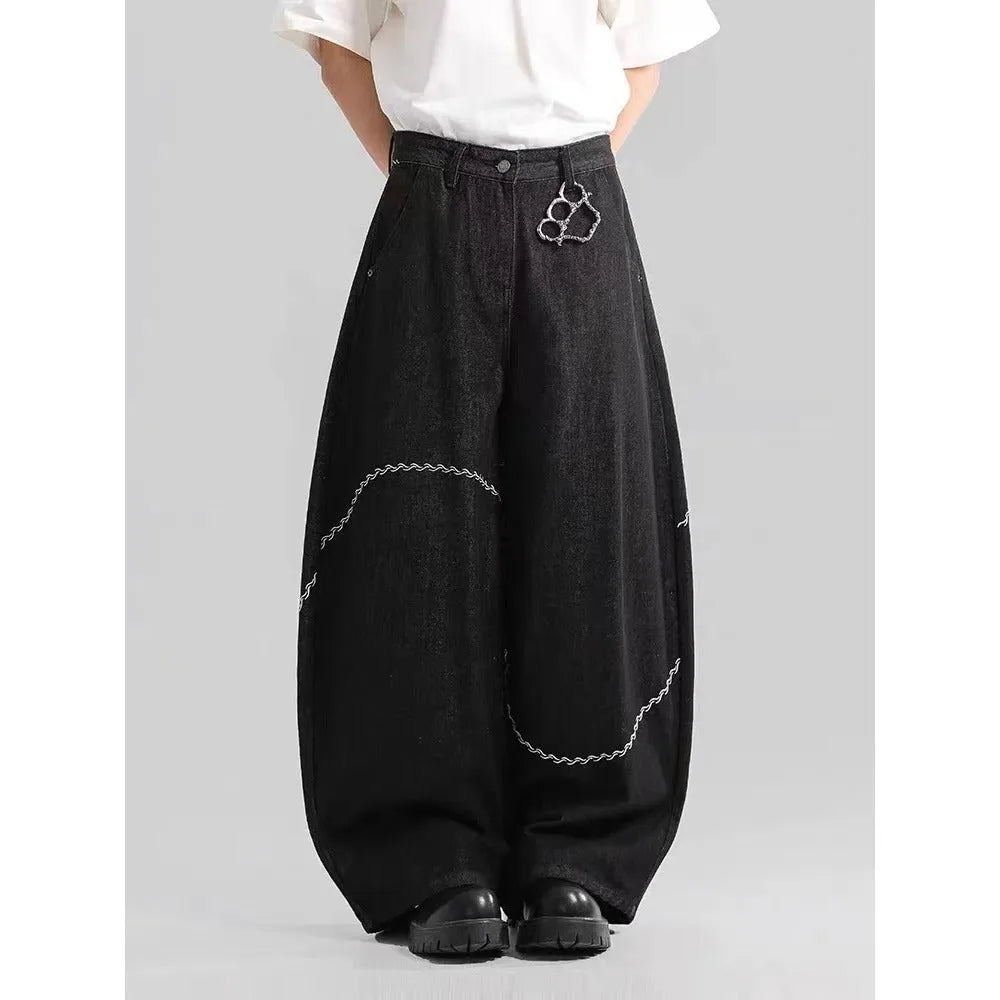 Black straight-leg denim trousers with mid-waist zip fly design on hanger
