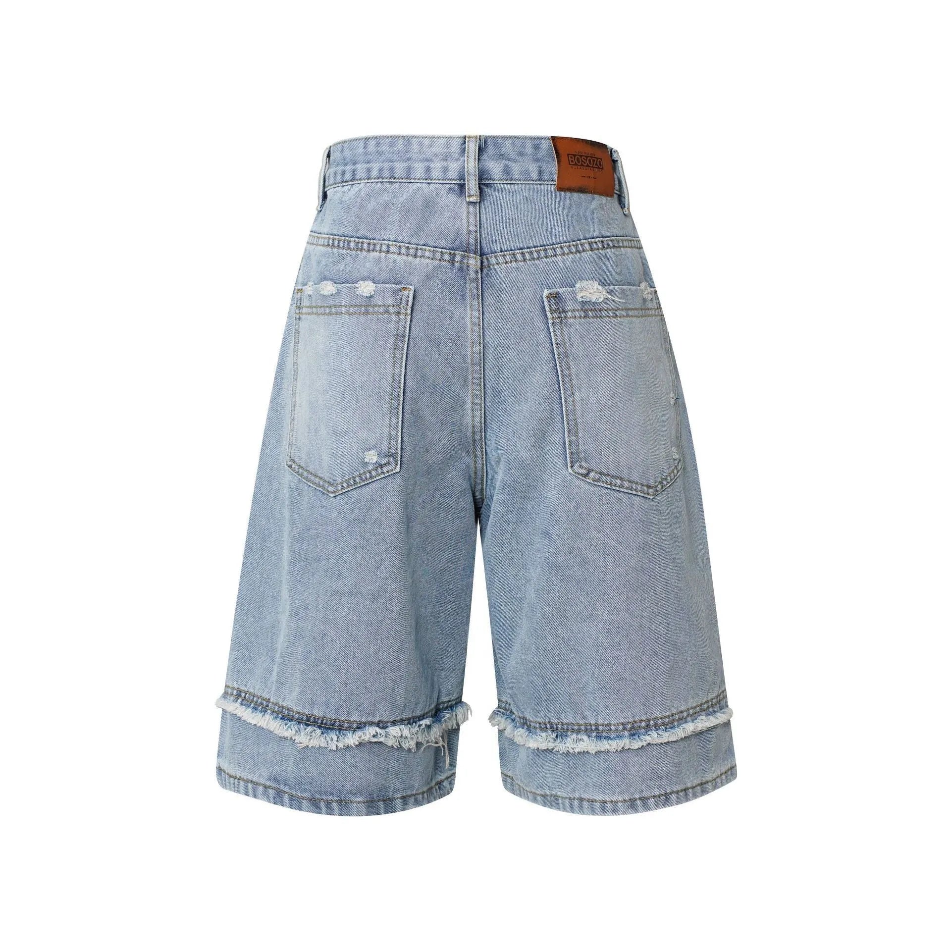 Distressed raw edge denim shorts in light blue, straight leg cropped cut.