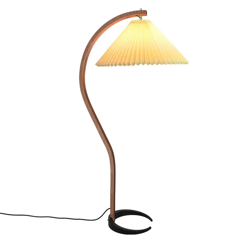 Retro vertical table lamp with fabric shade in choice of colours beside a sofa.