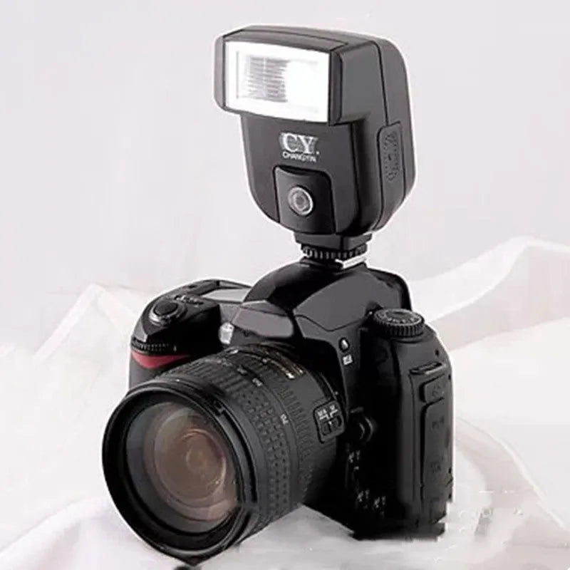Silver hot shoe camera flash unit mounted on an SLR, shown with its head tilted upwards.