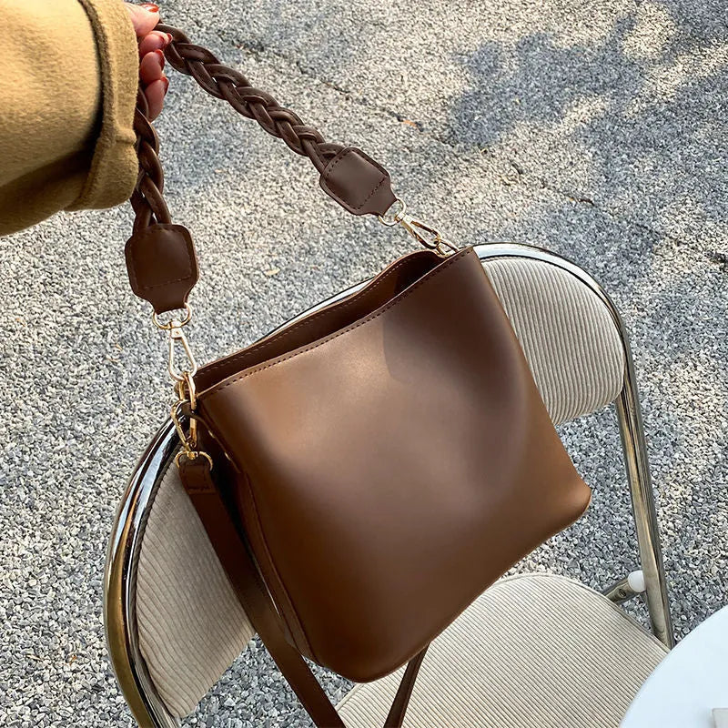 Retro-style khaki PU underarm bucket bag with a woven pattern and a crossbody strap.