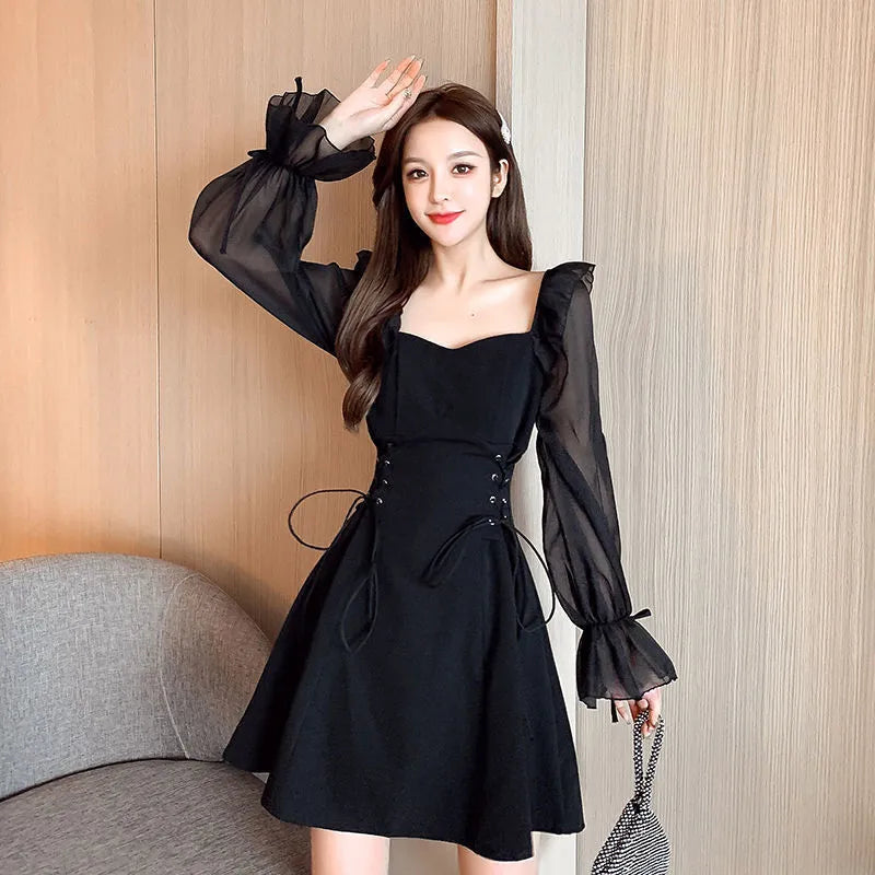 White chiffon patchwork dress with long sleeves and a slim, waist-defining fit on a mannequin.