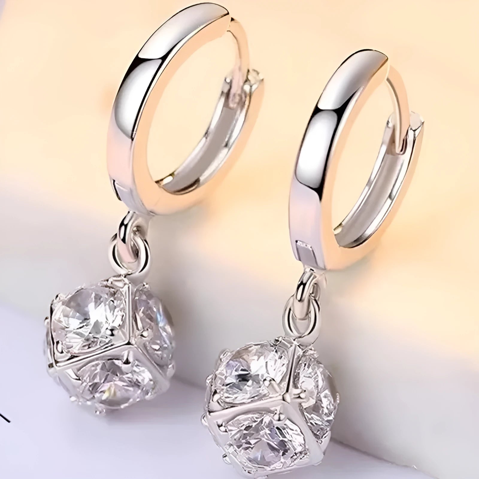 A pair of women's geometric rose design earrings in electroplated copper with zircon detail.
