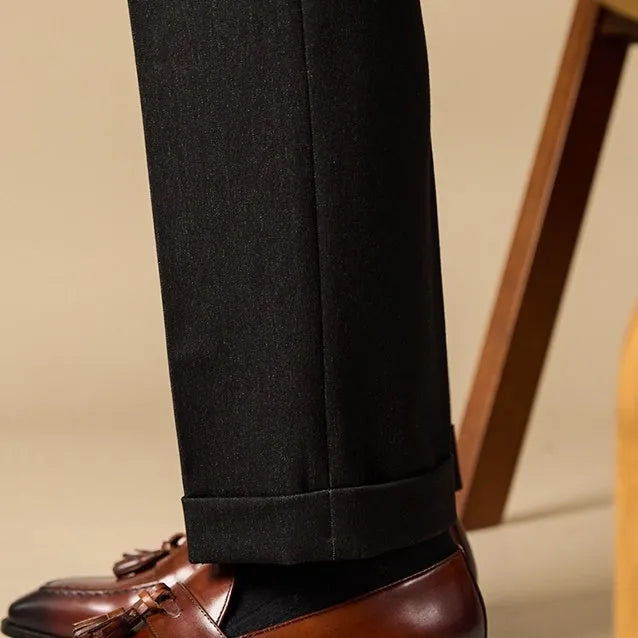 Black leather tassel loafers with polished finish and decorative tassel detail