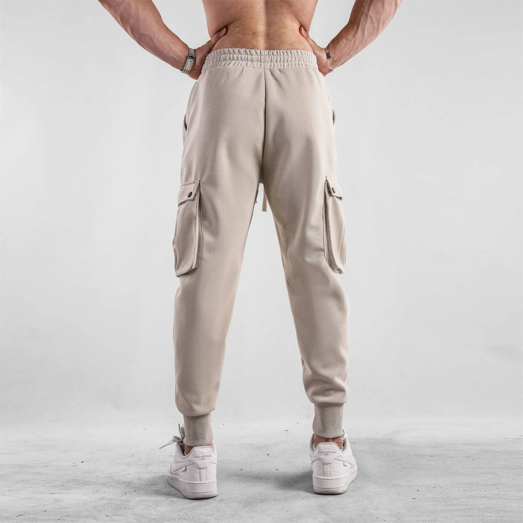 Men's loose fit multi-pocket cotton trousers with ankle ties in apricot colour