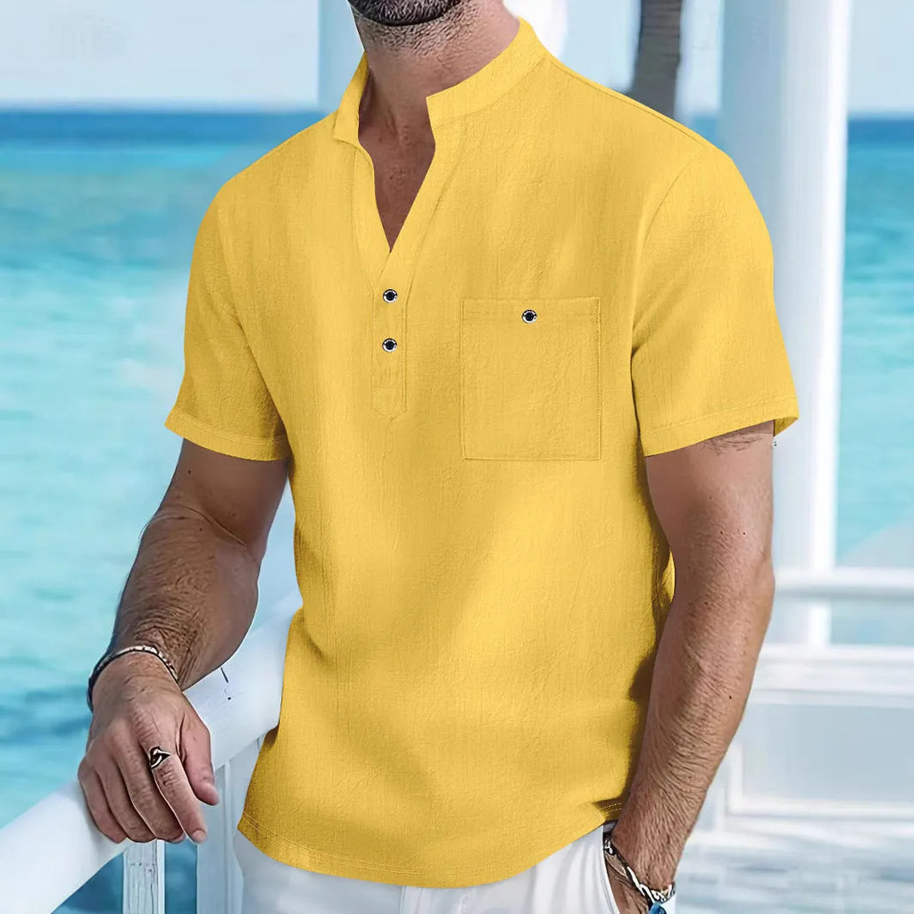 Man wearing a light apricot-coloured linen stand collar T-shirt with short sleeves and a loose fit.