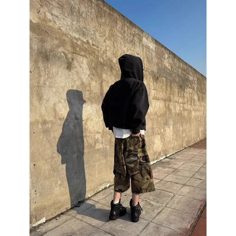 Men's straight-leg cropped jeans in camouflage pattern with patchwork detailing and distressed rips