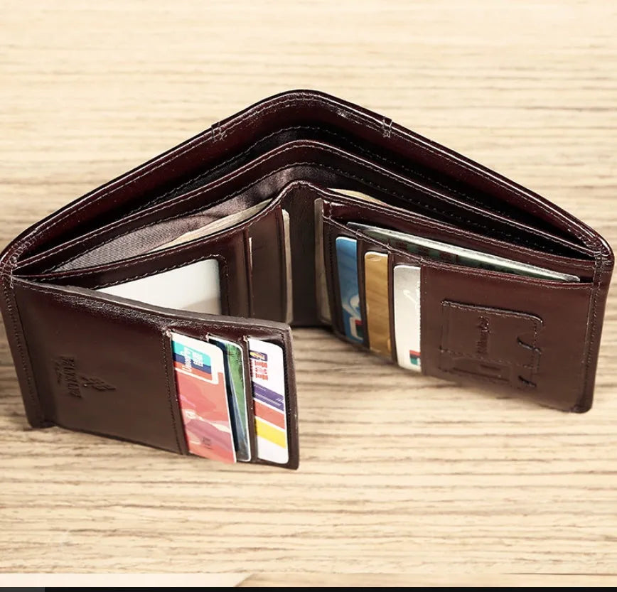 Men's brown leather bifold wallet open to show internal card slots, coin pocket, and photo holder.