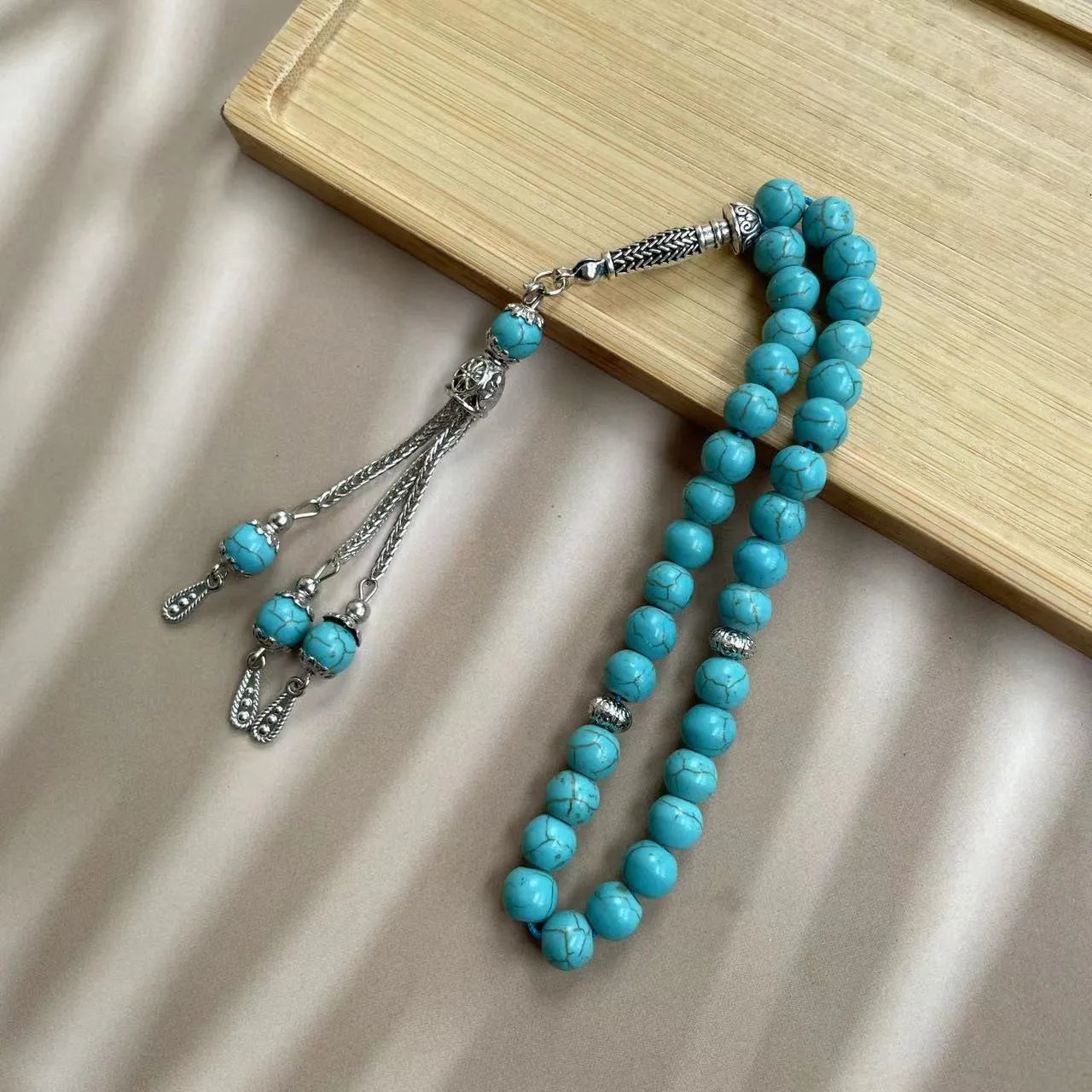 Sky blue stone Muslim dhikr bracelet with 8mm handmade beads on a wrist.