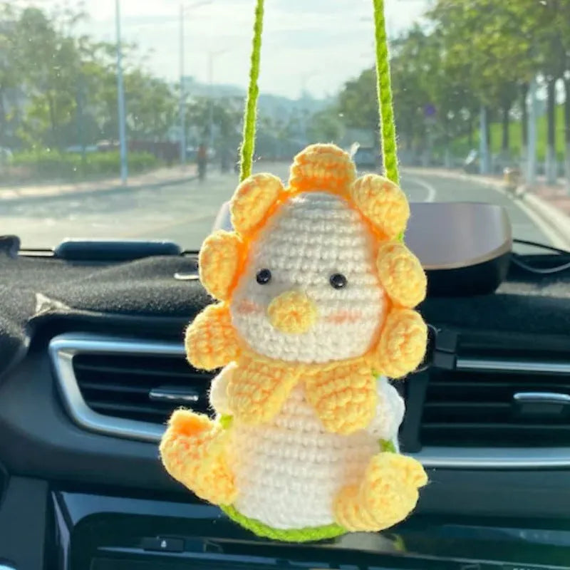 Knitted green and white car plant decoration with hanging rope