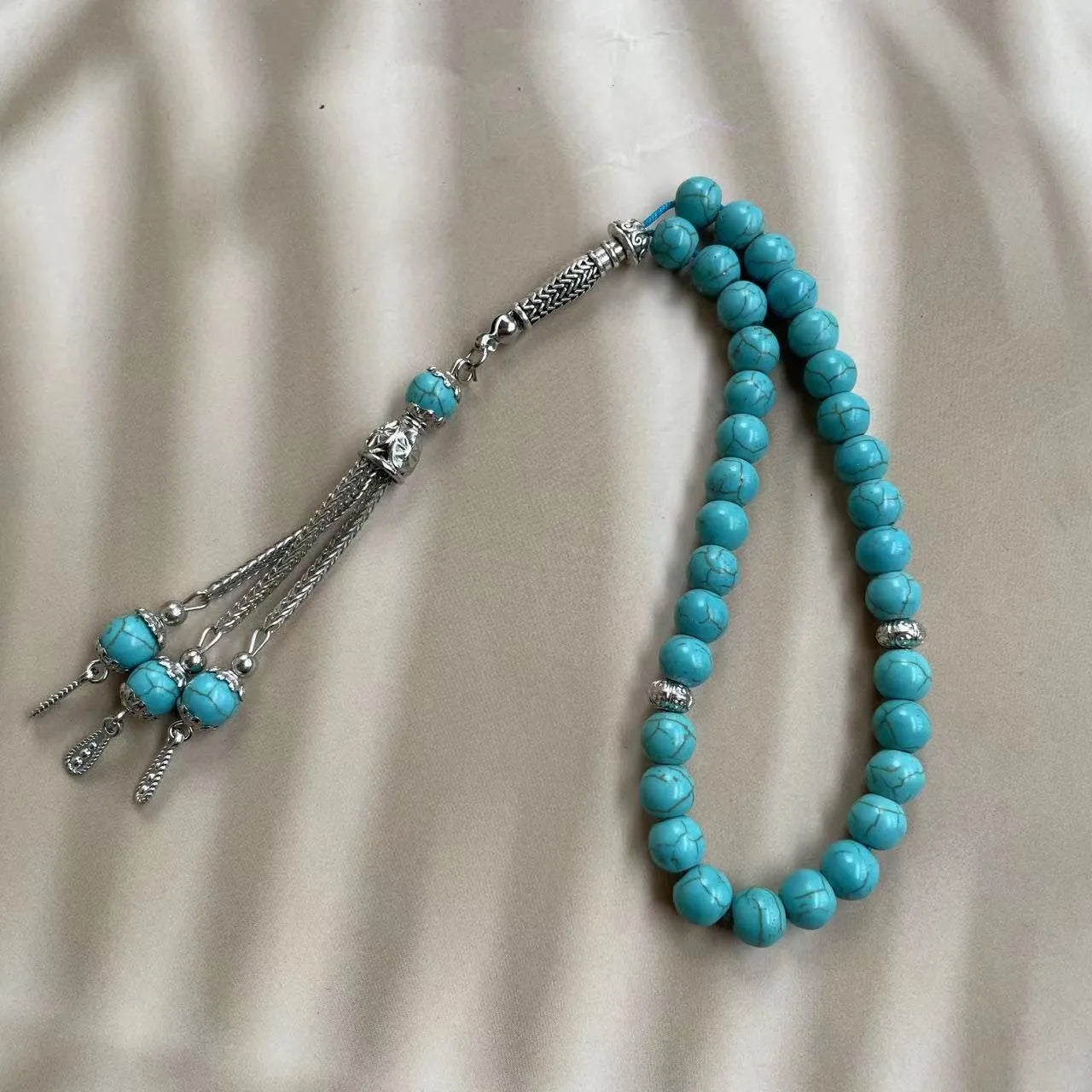 Sky blue stone Muslim dhikr bracelet with 8mm handmade beads on a wrist.
