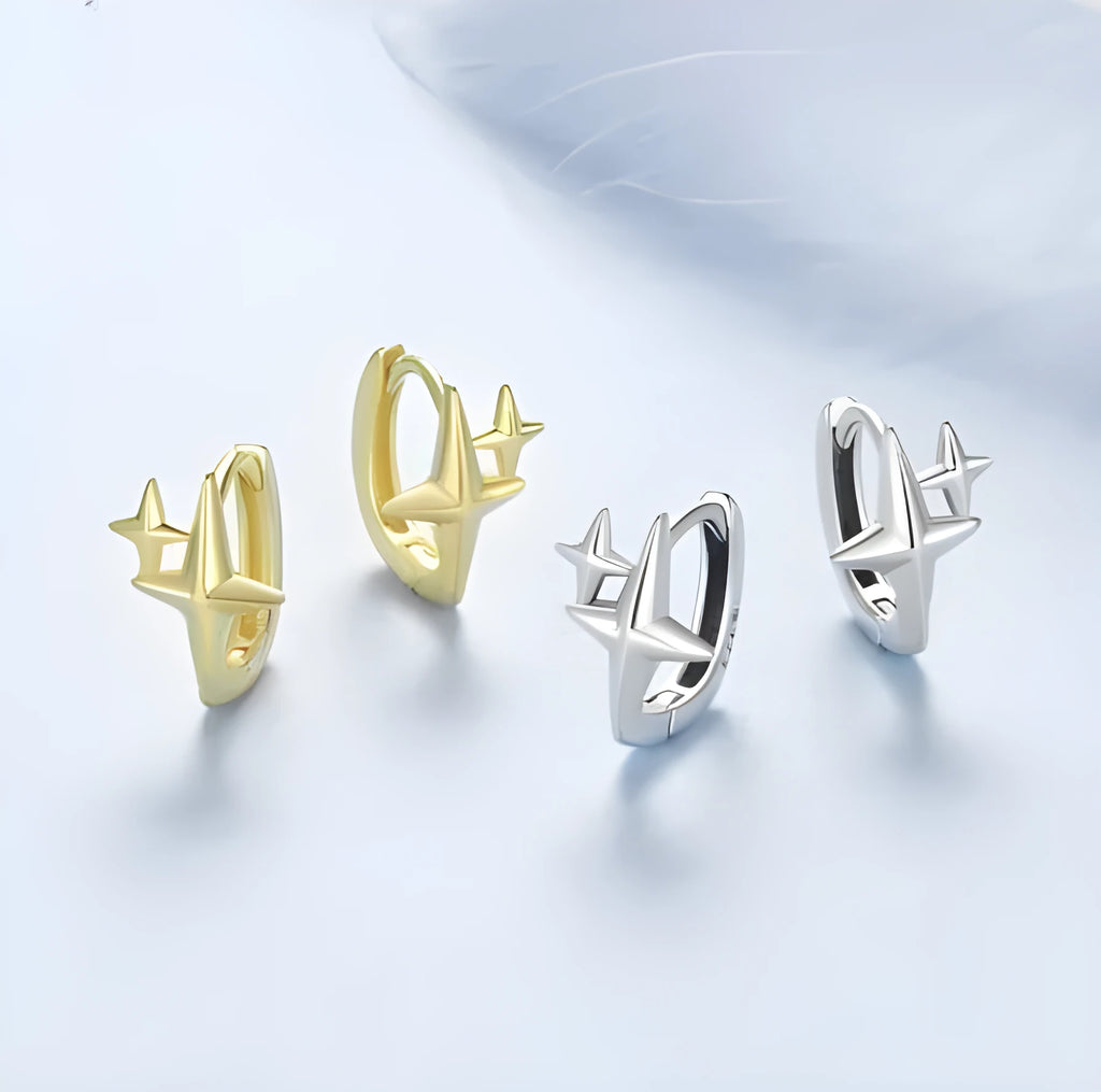 Sterling silver ear clips with minimalist star design and oxidation finish.