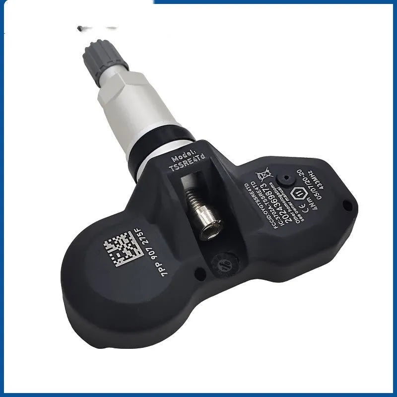 Black car tyre pressure monitor unit for Audi vehicles on white background
