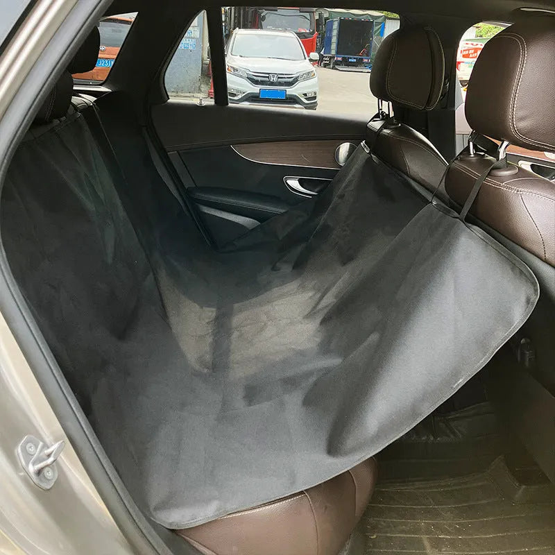 Grey cloth car pet mat with dog bone print protecting a car rear seat