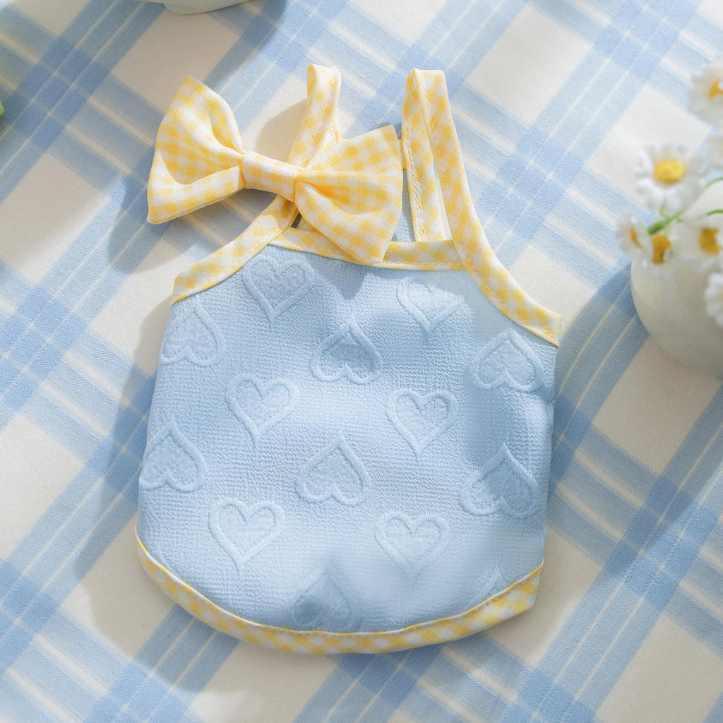 Small dog wearing an elastic heart relief texture bow suspenders vest in Bondi Blue
