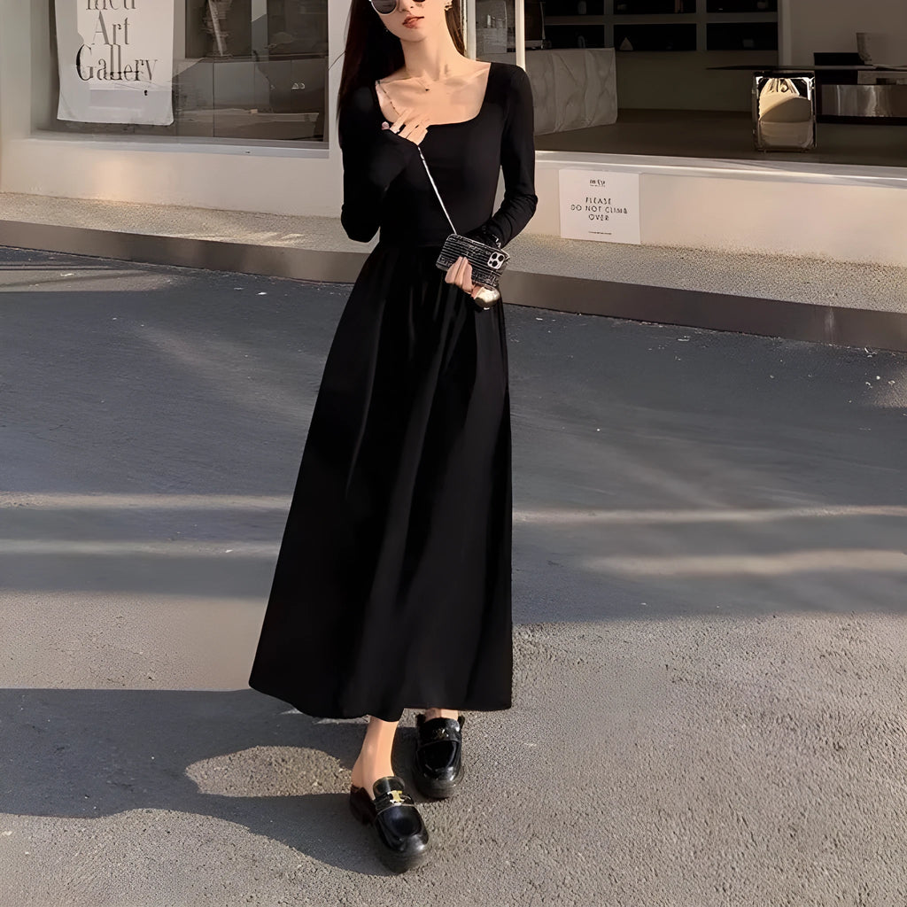 Women's black knitted dress with square collar, long sleeves, elastic waist, and A-line skirt.