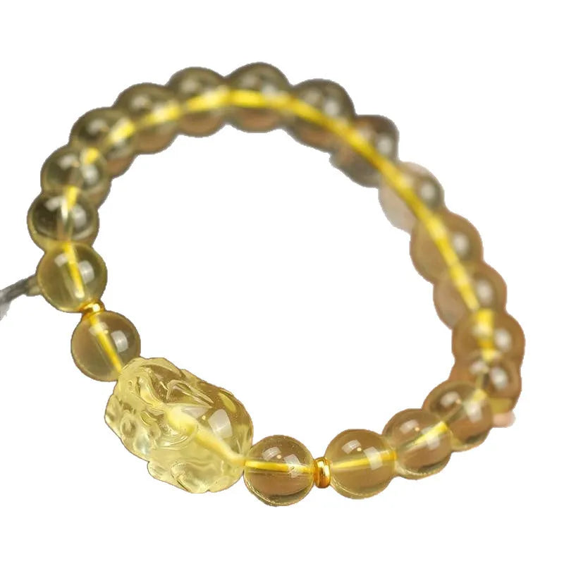 Yellow leather adjustable bracelet with artificial citrine beads and a Pi Xiu charm.