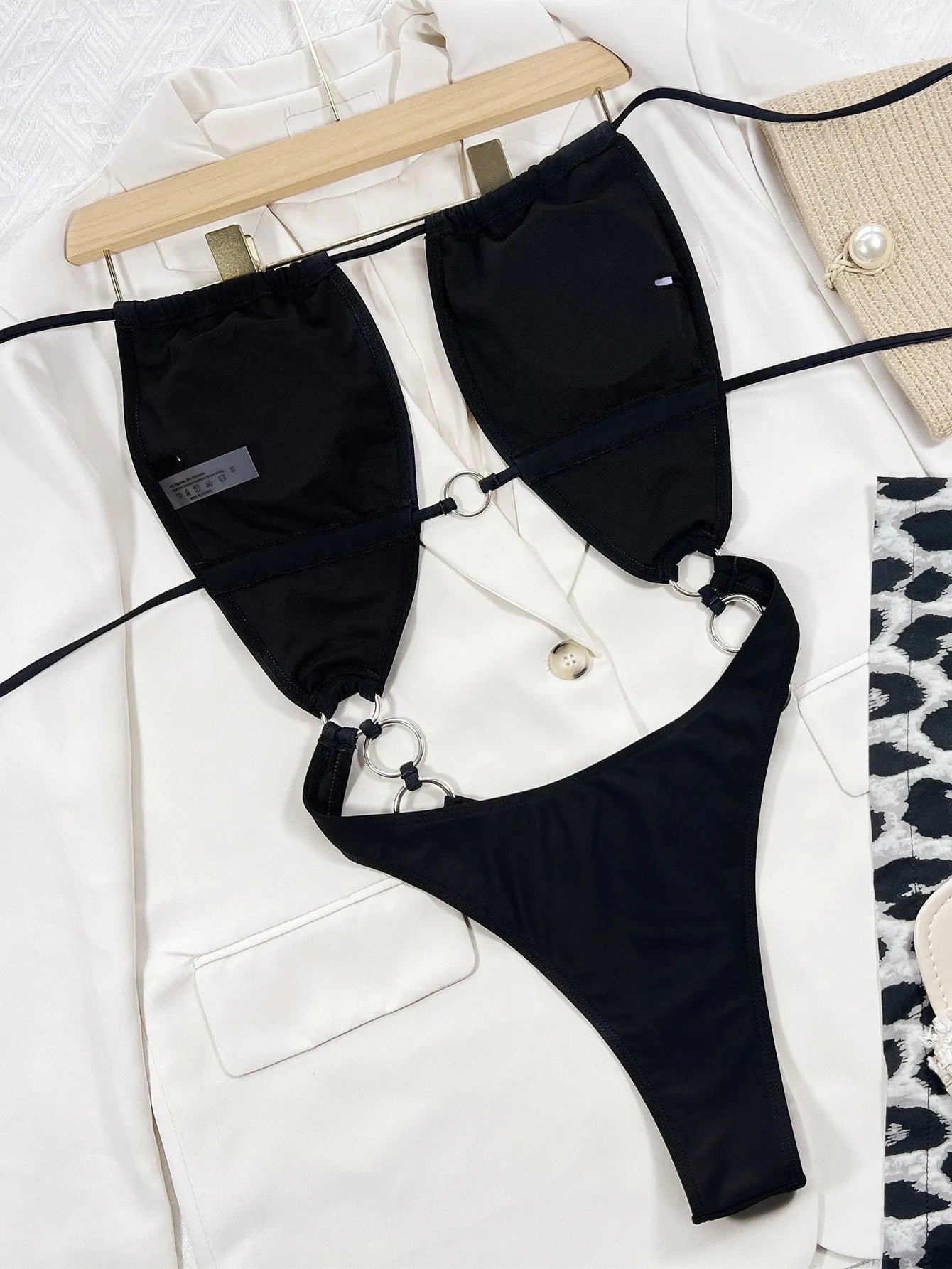 Black sleeveless one-piece swimming suit on a mannequin, front view.