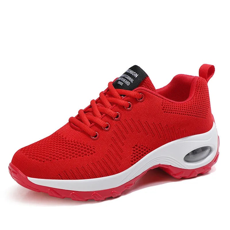 Women's red and black mesh front lace-up low top sneakers with round toe and flat mid-heel on a white background.