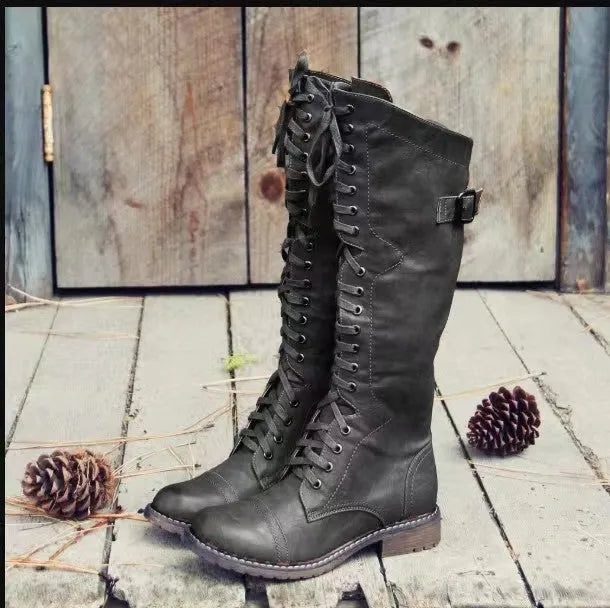 Women's black chunky heel high-leg ankle boots with a round toe on a plain background.